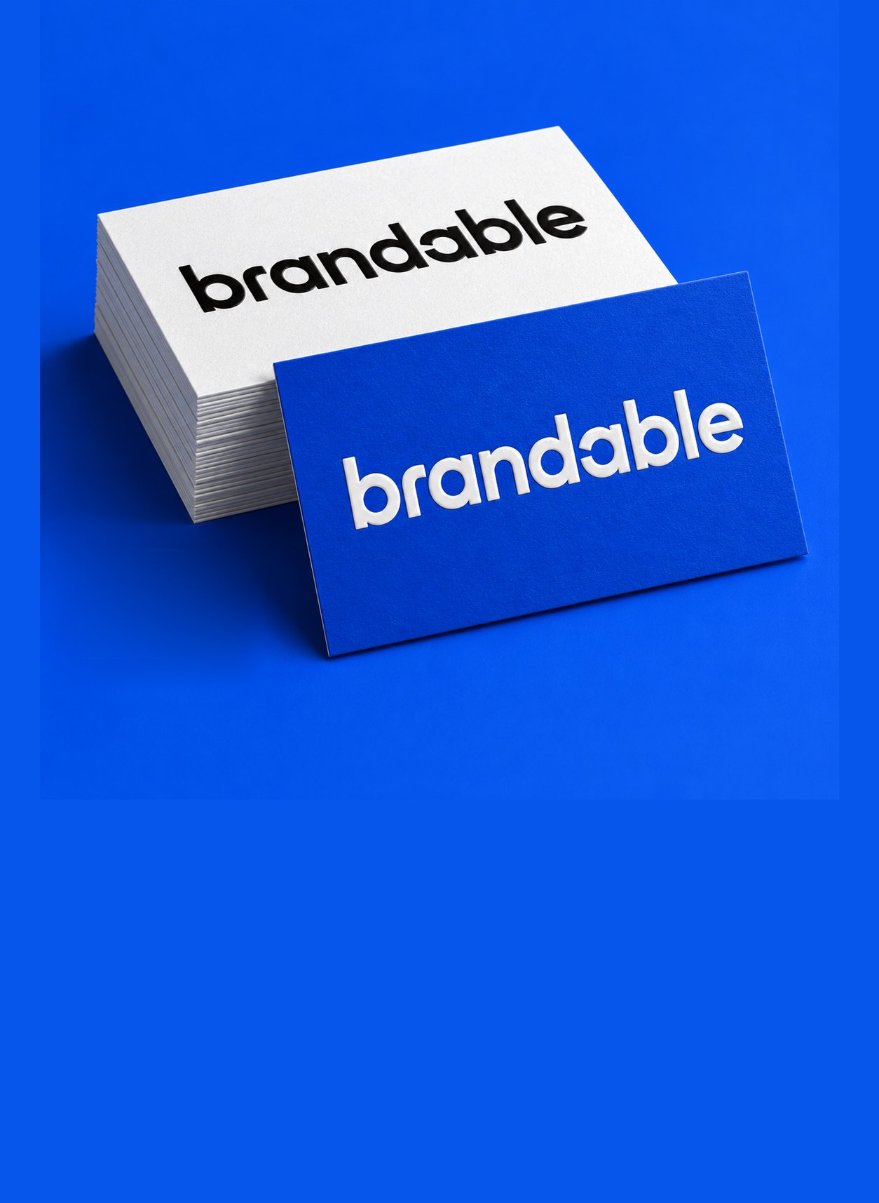 Stacks of business cards in white and cobalt, letterpressed with the Brandable wordmark