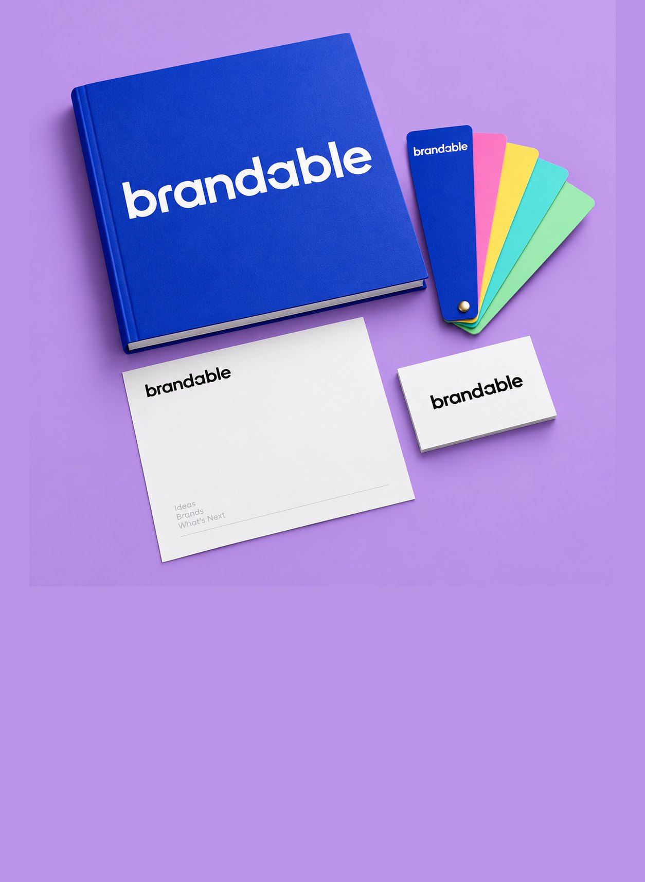 A cobalt brand book, color swatch fan and stationery on lavender