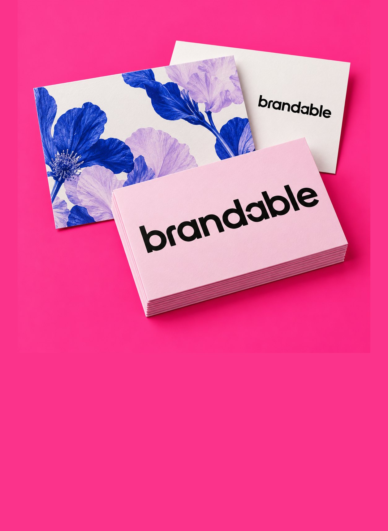 Floral postcards and a stack of pink business cards on hot pink