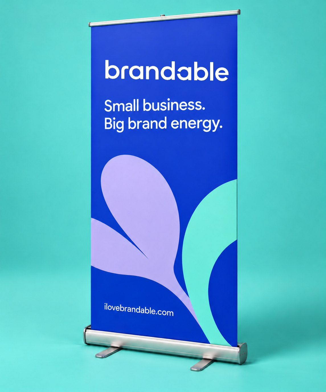 A cobalt retractable roll-up banner with the Brandable wordmark, standing against turquoise